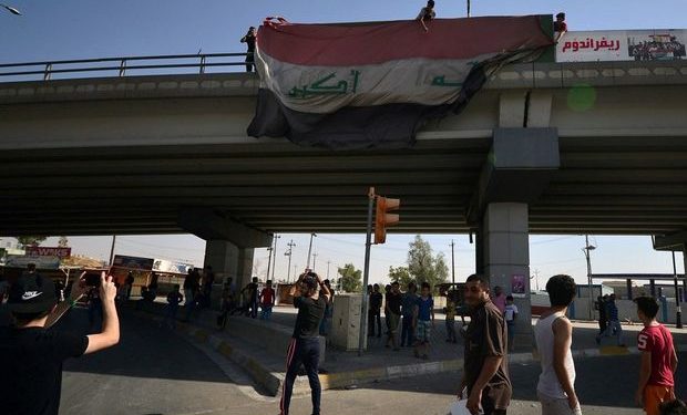 People hang a large Iraqi flag off a bridge in Kirkuk, Iraq October 16, 2017. REUTERS/Stringer NO RESALES. NO ARCHIVES